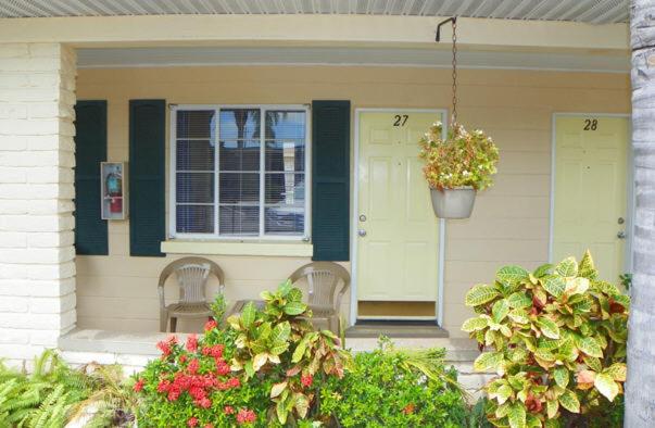 Guest room entrance porch with hanging plants and tropical flowers