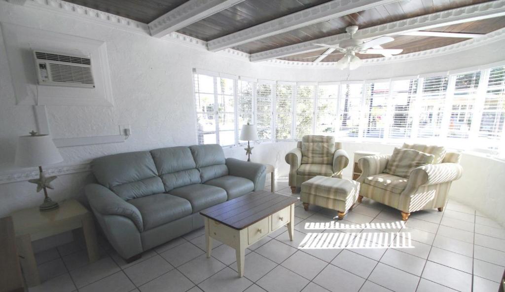 Guest common area with sofas, curved windows, and tiled floors